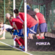 Redditch Hockey Men tucked in the goal to defend a penalty corner in red home kit